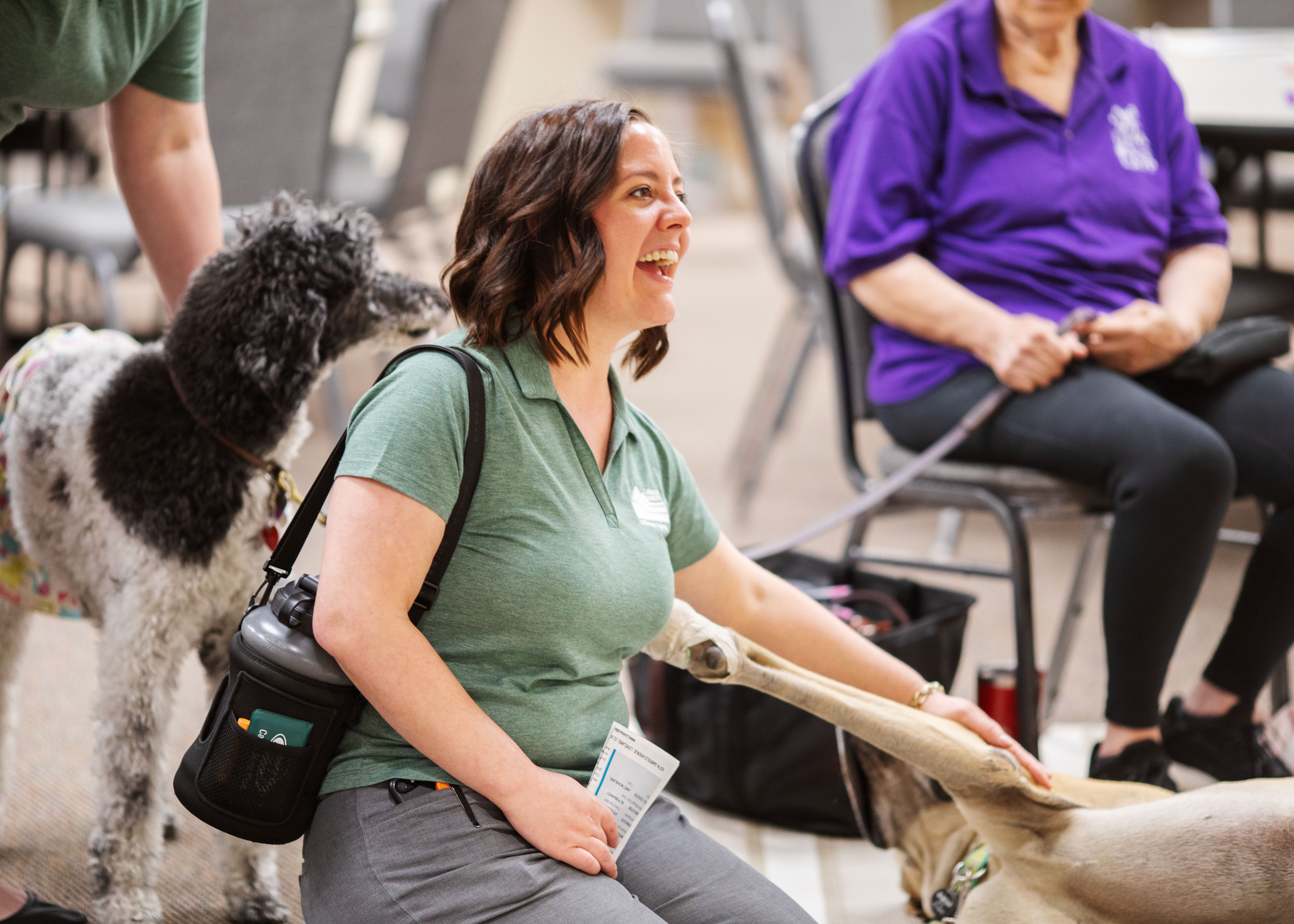 Image 6: Tiffany Ballew with the Office on Aging pets a therapy dog.