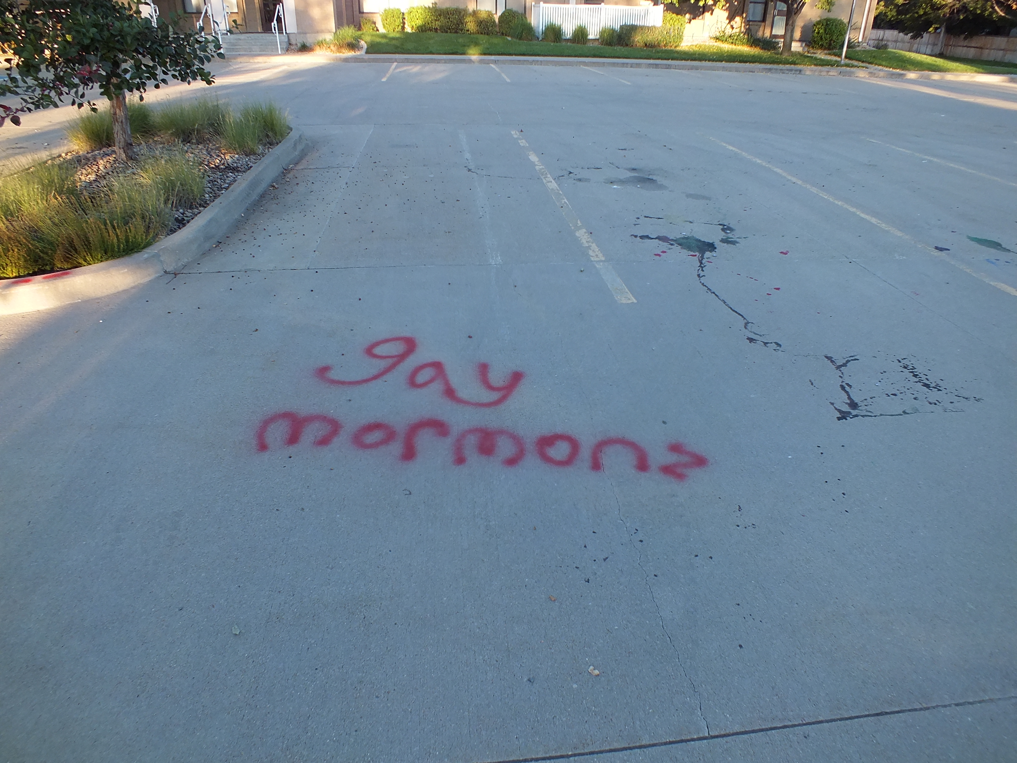 Image 3: red graffiti on pavement that says 
