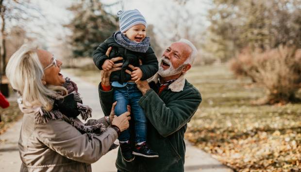 grandparents with toddler in autumn