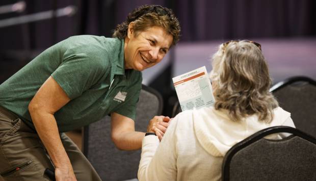 Katie Stieber in the Aging & Adult Services division greets an attendee.