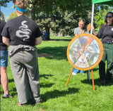 People engaging with a booth outdoors