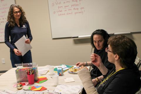 Three adults talk at a February 2025 session of the Parent Cafe, put on by The Matthews House