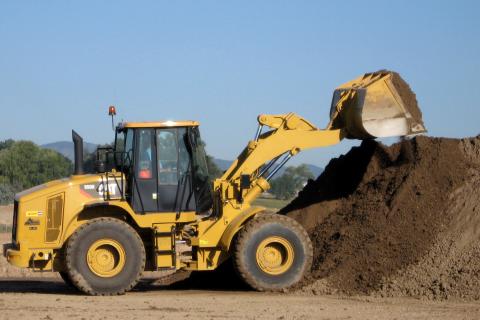 Loader stockpiling gravel