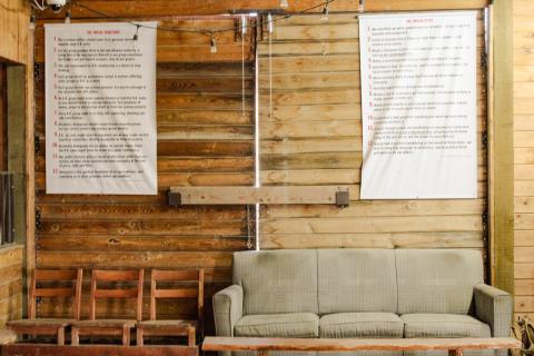 Three chairs and a couch are lined up along a wall at Harvest Farm in Wellington, Colorado