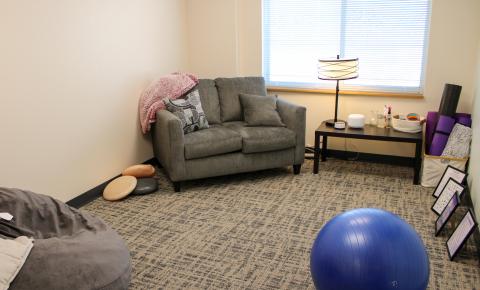 Crossroads Safehouse & Services' calming room for staff, with a couch, bean bag, exercise ball, yoga mats and more