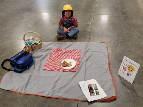 Ein Larimer County 4-H-Mitglied bei Creative Cooks. Sein Display liegt ausgebreitet vor ihm. Es handelt sich um ein Picknick zum Thema Bauarbeiter/Konstruktion.