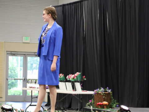 A 4-H member shows off the blue suit she purchased as part of the Artistic Clothing project. 