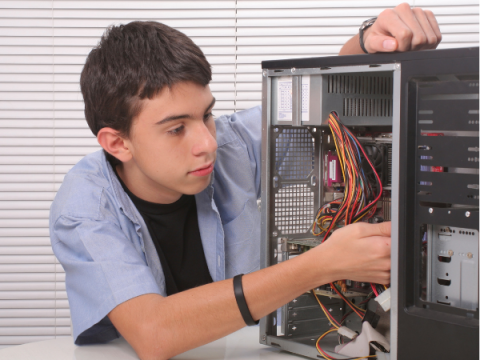 A teenager works on a computer