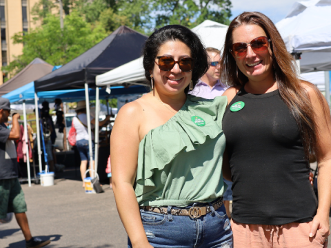 Two Market Ambassadors stand at the Larimer County Farmers' Market
