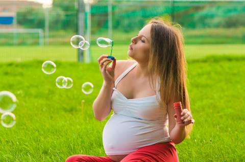 pregnant woman blowing bubbles pregnant woman blowing bubbles