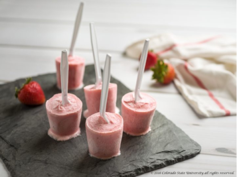 Frozen Strawberry Yogurt Pops sit on a counter