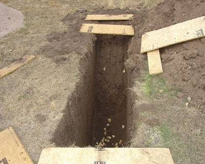 A one foot width by three foot length trench in the ground.