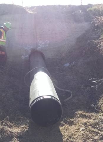 A culvert liner being inserted into the existing culvert.