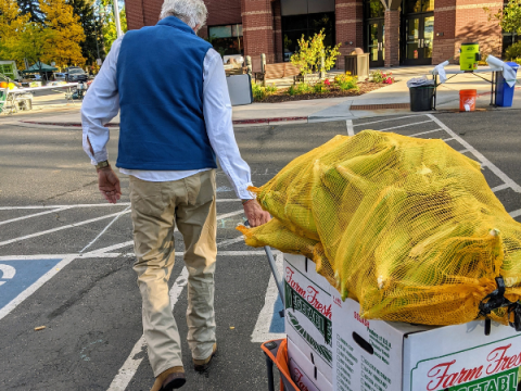 Produce being picked up from a farmer at the Farmers' Market Produce being picked up from a farmer at the Farmers' Market