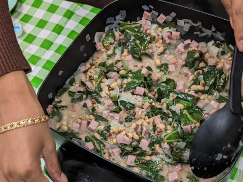 Black Eyed Pea & Collared Green Soup being made in a table-top skillet in an EFNEP Class