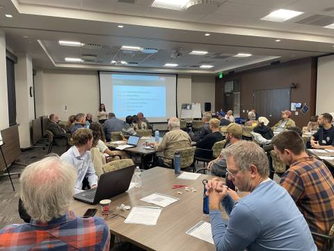 Members from the public sitting in a room for a vision and goals workshop