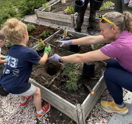 Fort Collins Montessori School students learning about gardening and planting in their schools new ADA garden beds.
