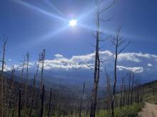 Top of Pennock Pass, sun shine, clouds, mountains, burn scar